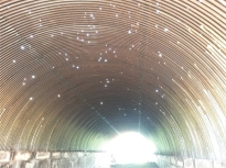 Looking upward in a storage tunnel, roof shrapnel-punctured by a grenade during the civil war, gives the illusion of a planetarium.